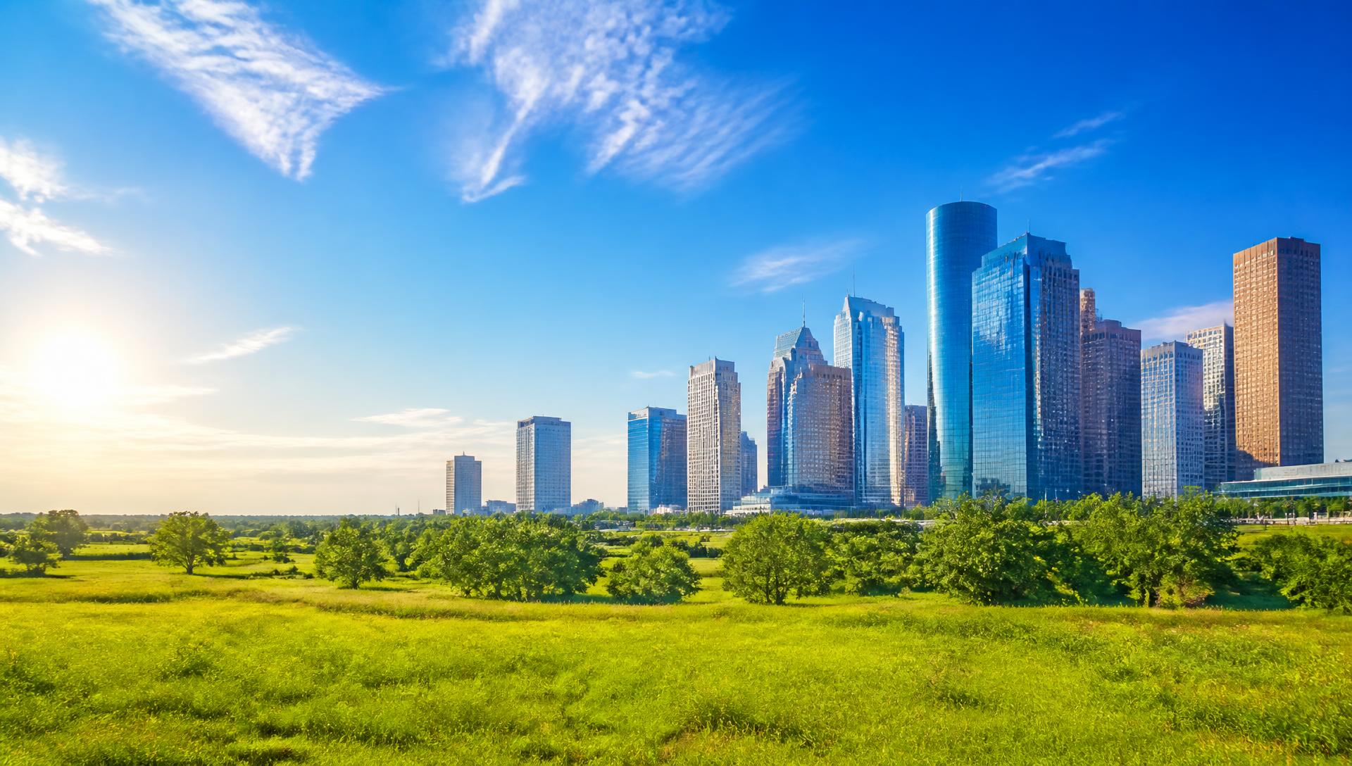 Bright midday view of downtown Houston under a clear blue sky
